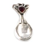 By Omar Ramsden, an Arts and Crafts silver caddy spoon, London 1919, spot-hammered fig-shaped