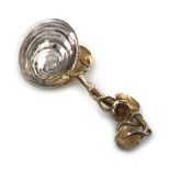 A Victorian parcel-gilt cast silver caddy spoon, by Francis Higgins, London 1852, shell bowl, with a