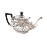 A late-Victorian silver teapot, by Jenkins & Timm, Sheffield 1897, oblong bellied form, embossed