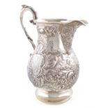 A George IV silver beer jug, by William Eley II, London 1824, baluster form, embossed with a stag