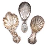 A small collection of three antique Sheffield made silver caddy spoons, comprising: a Victorian