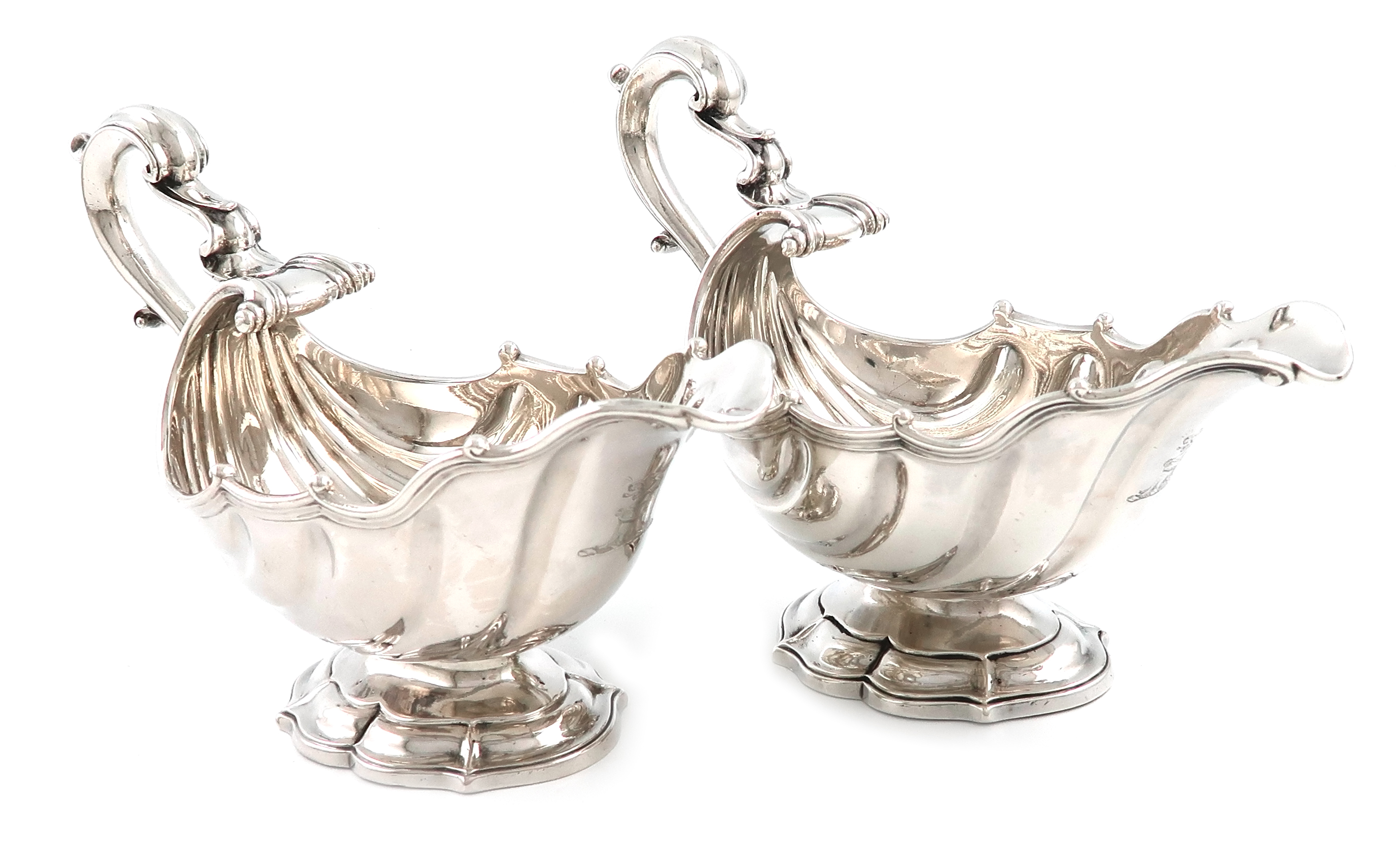 A matched pair of George II silver sauce boats, one by Ayme Videau, the other by Lewis Hamon, London