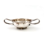 By A. E. Jones, an Arts and Crafts silver two-handled bowl, Birmingham 1913, the circular bowl