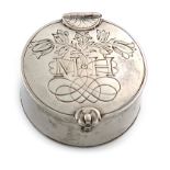 A 17th century silver box, unmarked, circular form, the cover engraved with tulips and a rose, and