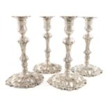 A set of four George II silver cast candlesticks, by William Gould, London 1749, baluster columns,