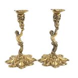 A pair of George IV cast silver-gilt candlesticks, by Sebastian Crespell II, London 1824, the