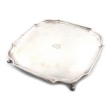 A silver salver, by D and J Wellby, London 1920, square form, canted corners, moulded border, the