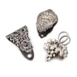 Two silver paper clips, stamped STERLING, one with pierced foliate scroll decoration and one with