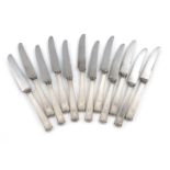 A set of twelve Japanese silver-handled dessert knives, the handles of tapering rectangular form,