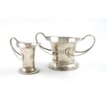 An Edwardian Art Nouveau silver cream jug and sugar bowl, by George Unite, Birmingham 1911, tapering