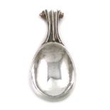 By Omar Ramsden, an Arts and Crafts silver caddy spoon, London 1927, spot-hammered bowl, fluted