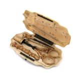 λA 19th century French ivory and gold sewing case, shaped rectangular form, the hinged cover opens