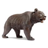 A BLACK FOREST CARVED LINDEN WOOD MODEL OF A PROWLING BEAR LATE 19TH CENTURY with glass eyes; 17cm