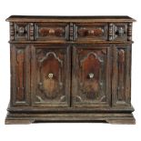 AN ITALIAN BAROQUE WALNUT CREDENZA TUSCANY, 17TH CENTURY the rectangular moulded top above a pair of