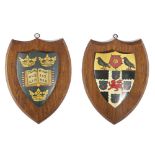 A PAIR OF CARVED OAK AND PAINTED HERALDIC SHIELDS MID-20TH CENTURY each painted with a coat of arms,