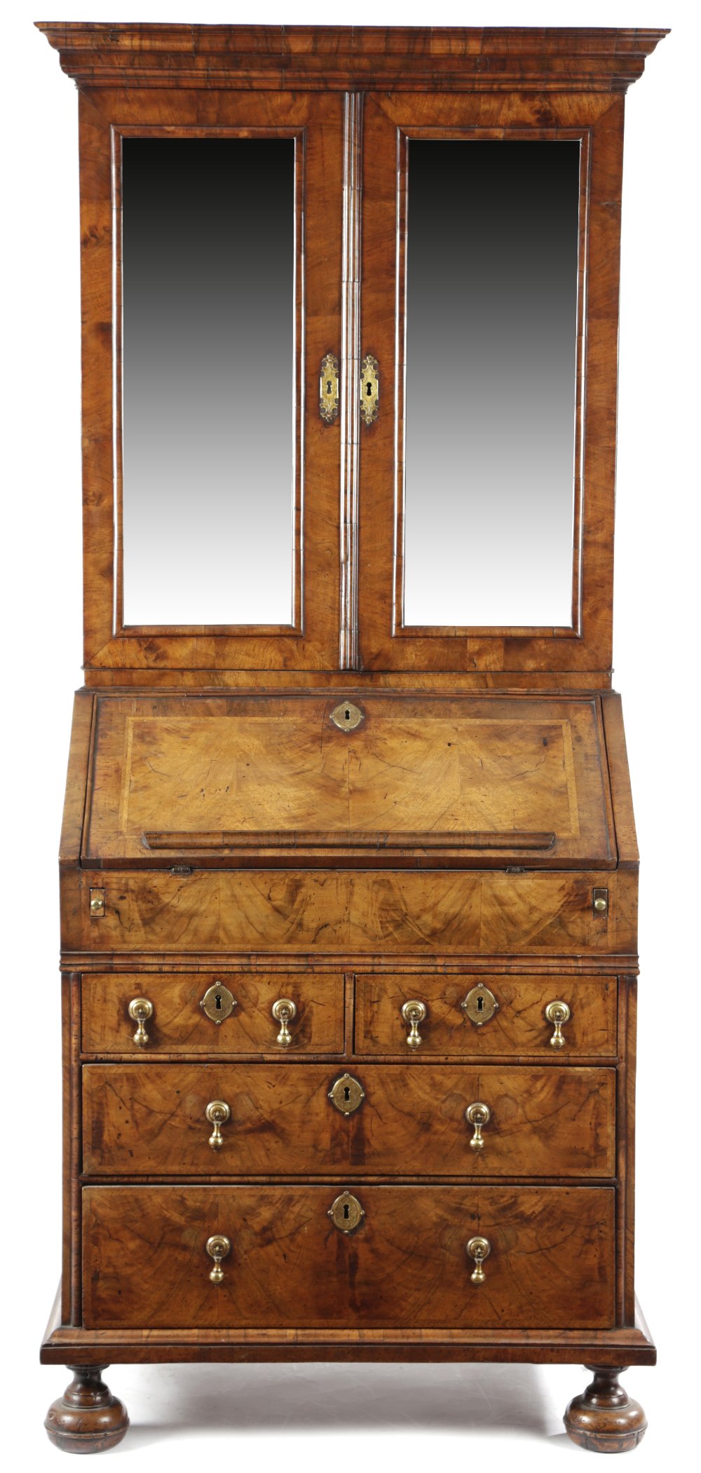 A GEORGE I WALNUT BUREAU BOOKCASE C.1715-20 with cross and feather banding, the moulded cornice