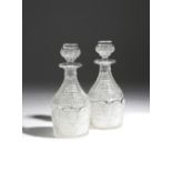 A PAIR OF LATE REGENCY CUT-GLASS MAGNUM DECANTERS C.1820 each with a stopper, with stepped necks and