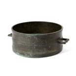 A BRONZE BUSHEL MEASURE PROBABLY EARLY 18TH CENTURY the moulded body with a pair of angular lug