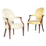 TWO GEORGE III MAHOGANY OPEN ARMCHAIRS IN 'FRENCH HEPPLEWHITE' STYLE, C.1790 each with a padded oval