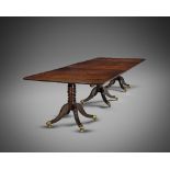 A REGENCY MAHOGANY TRIPLE PILLAR DINING TABLE C.1810 the well figured top with two additional