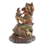 A VICTORIAN PAINTED CAST IRON DOORSTOP MID-19TH CENTURY depicting a seated Judy holding a Punch