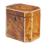 λ A GEORGE III BLONDE TORTOISESHELL TEA CADDY C.1800 of canted form, inlaid with ivory stringing,