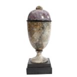 A DERBYSHIRE FLUORSPAR URN 19TH CENTURY of ovoid shape, with a button finial and on a stepped