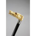 λ A VICTORIAN IVORY HANDLED WALKING CANE C.1850 carved with a greyhound dog's head, with glass eyes,