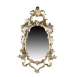 A GILTWOOD WALL MIRROR IN GEORGE II STYLE 19TH CENTURY the shaped plate within a 'C' scroll, branch,