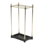 A BRASS STICKSTAND LATE 19TH / EARLY 20TH CENTURY with six divisions, a cast iron base and a lift-