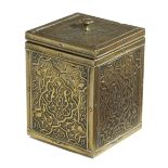 AN ISLAMIC BRASS TEA CADDY LATE 19TH CENTURY decorated with panels of scrolling leaves, with a
