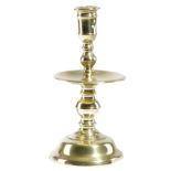 A DUTCH BRASS HEEMSKERK CANDLESTICK SECOND HALF 17TH CENTURY with a pierced socket, on a turned stem