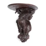 A BLACK FOREST CARVED LINDENWOOD EAGLE WALL BRACKET LATE 19TH / EARLY 20TH CENTURY the top supported