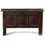 A CHARLES II BOARDED OAK COFFER C.1660 of six plank construction, the later hinged top with a