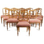 A SET OF THIRTEEN VICTORIAN OAK GOTHIC REVIVAL DINING CHAIRS C.1880 each with an arched moulded back