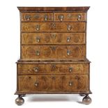 A QUEEN ANNE WALNUT CHEST ON CHEST C.1710 the quarter veneered crossbanded top above two short and