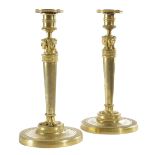 A NEAR PAIR OF FRENCH EMPIRE ORMOLU CANDLESTICKS IN THE MANNER OF JEAN-DEMOSTHENE DUGOURC (FRENCH