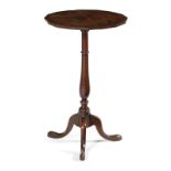 A GEORGE III OAK TRIPOD TABLE C.1770 the circular fixed top with a faceted edge, on a baluster