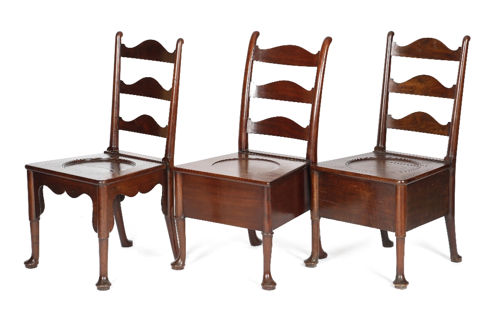 THREE GEORGE II MAHOGANY COMMODE CHAIRS C.1740-50 each with a shaped ladder back, above a dished