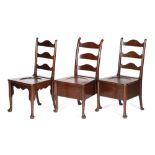 THREE GEORGE II MAHOGANY COMMODE CHAIRS C.1740-50 each with a shaped ladder back, above a dished