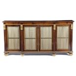 λ A REGENCY ROSEWOOD BREAKFRONT SIDE CABINET C.1815-20 with parcel gilt decoration and egg and