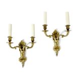 A PAIR OF FRENCH ORMOLU TWIN-LIGHT WALL LIGHTS IN REGENCE STYLE decorated with leaves, together with