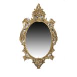 A GEORGE III STYLE GILTWOOD WALL MIRROR the later oval plate within a leaf, flower and '