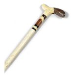 A SAILOR'S WHALEBONE WALKING CANE LATE 19TH CENTURY the part marine ivory and walnut handle above
