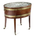 A GEORGE III MAHOGANY OVAL WINE COOLER ON STAND C.1790-1800 of staved construction, brass bound