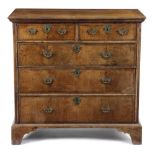 A GEORGE I WALNUT CHEST C.1715 the quarter veneered top with cross and feather banding, above two