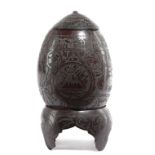 AN INDIAN CARVED COCONUT CUP AND COVER ON STAND 19TH CENTURY relief decorated with bands, with