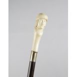 λ AN IVORY HANDLED WALKING CANE LATE 19TH / EARLY 20TH CENTURY carved in the form of a head of an