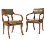 A PAIR OF REGENCY MAHOGANY OPEN ARMCHAIRS C.1815 with a padded leather covered back and drop-in