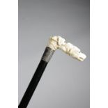 λ A LATE VICTORIAN IVORY HANDLED WALKING CANE C.1880 the handle carved with two dog's heads, with